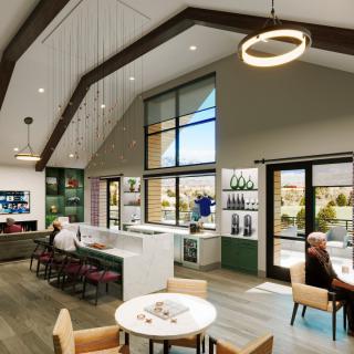 A modern open-concept living space featuring a kitchen and seating area with ample natural lighting.