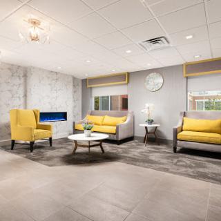 A modern lounge area featuring stylish yellow chairs and a contemporary design.