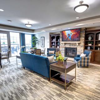A modern living room with comfortable seating and a cozy fireplace.