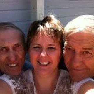 A cheerful group selfie of three people outdoors.