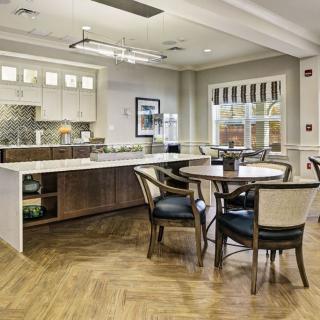 A contemporary kitchen and dining area with an open layout and wood flooring.