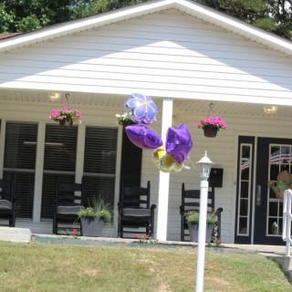 A house with a front porch decorated with flowers and balloons.