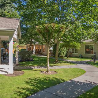 A peaceful suburban neighborhood with well-maintained yards and sidewalks.