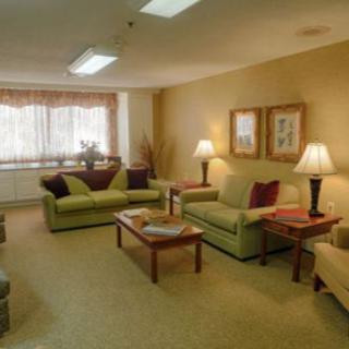 A cozy living room with sofas, lamps, and a coffee table.
