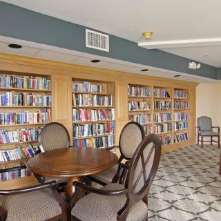 A cozy library corner with bookshelves and a seating area.