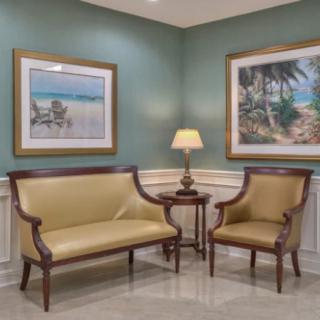 A classic lounge area with elegant seating and framed artwork.