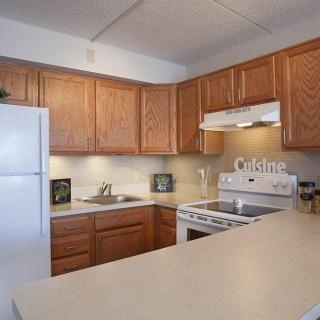 Modern kitchen with wooden cabinets and appliances.