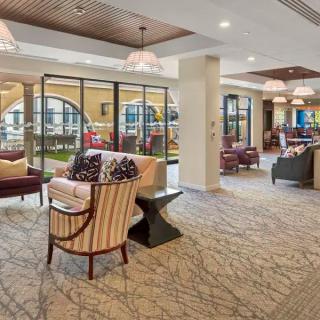 A luxurious lobby interior featuring comfortable seating and elegant decor.