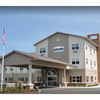 A modern healthcare facility with an American flag displayed at the entrance.