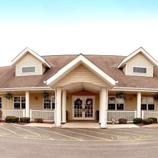 A single-story building with a sloped roof and large entrance.