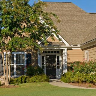 A suburban house with a well-maintained lawn and garden.