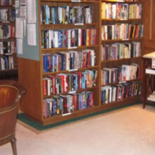 A cozy library corner with bookshelves filled with assorted books.