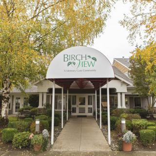 Entrance to the Birchview building surrounded by trees and landscaping.