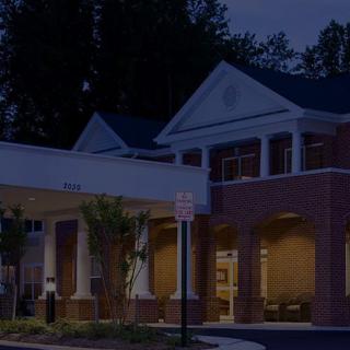 Exterior view of a lit building entrance at night.