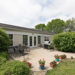 A cozy backyard patio with outdoor furniture and potted plants.