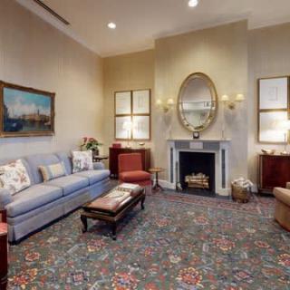 A traditional living room with elegant furniture and a cozy fireplace.
