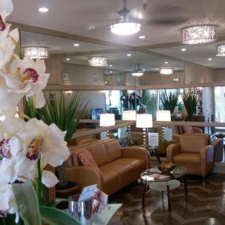 A modern lounge area with comfortable seating and elegant orchids.