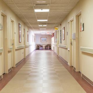 A well-lit corridor in a hospital, showcasing the typical layout and design of healthcare facilities.
