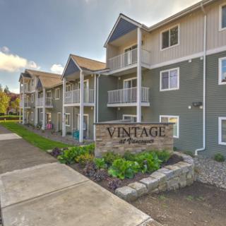 A beautifully designed vintage apartment complex showcasing modern architecture and well-maintained landscaping.
