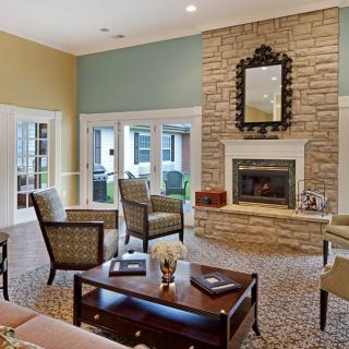 Cozy living room with a stone fireplace and comfortable seating arrangement.