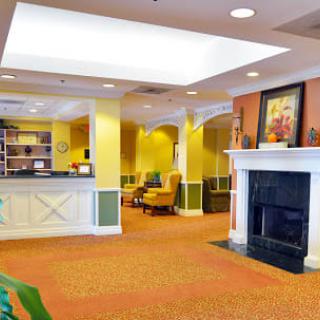 A welcoming lobby area featuring a reception desk and a cozy seating nook by the fireplace.
