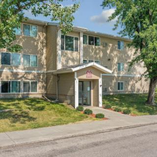 A sunny day view of a two-story residential apartment building.