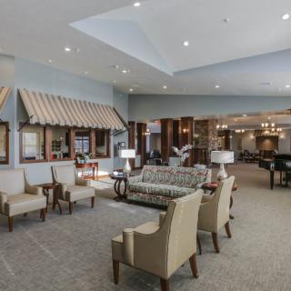 A spacious and elegantly designed lobby featuring comfortable seating and modern lighting.