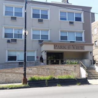 A residential building with multiple windows and an accessible entrance.
