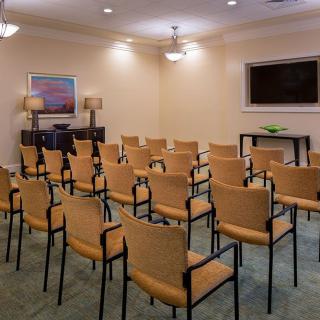 A conference room with rows of chairs arranged for a meeting.