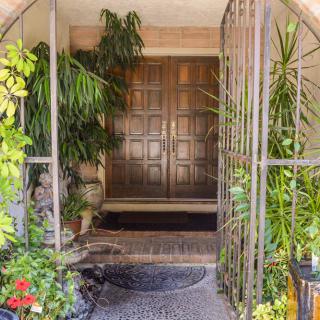 A welcoming entrance surrounded by lush greenery.
