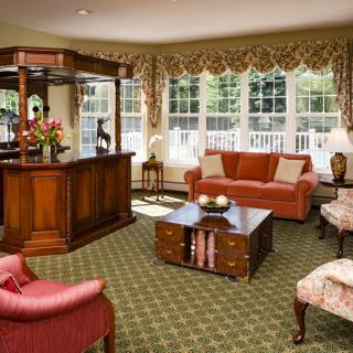 A cozy living room with elegant furniture and large windows.