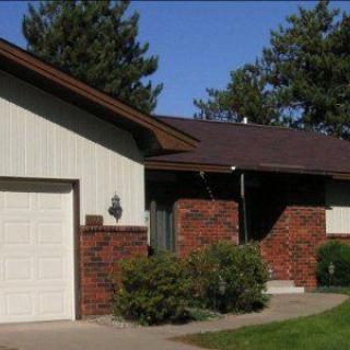 A suburban house with a brick facade and attached garage.