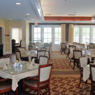 An elegant dining room with neatly arranged tables and chairs.