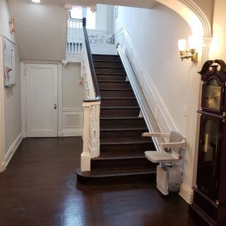 A classic interior hallway with a wooden staircase and elegant design.