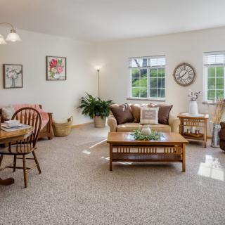 A cozy living room with a dining area featuring comfortable furniture and tasteful decor.