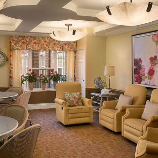 A cozy living room with comfortable seating and warm lighting.