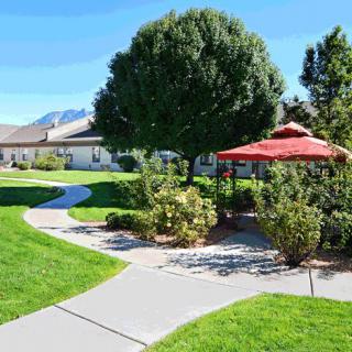 A beautifully landscaped garden with a winding pathway and a gazebo.