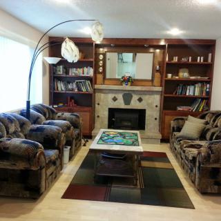 A cozy living room with couches, a coffee table, and a fireplace.