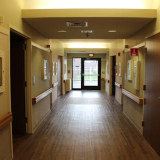 A view down a well-lit hallway in a healthcare facility.