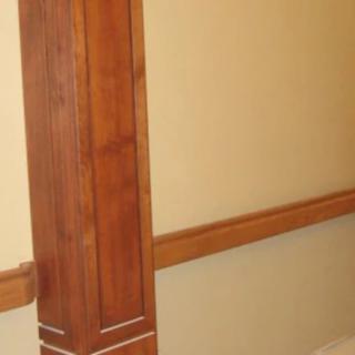 A view of a wall with wooden paneling and molding, showcasing classic interior design elements.