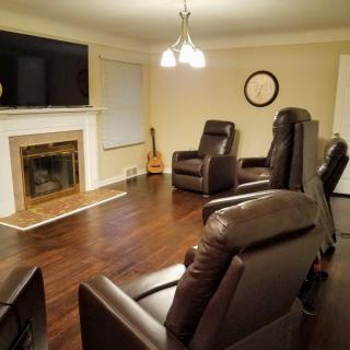 Cozy living room with recliner chairs and a fireplace.