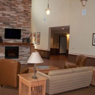 A cozy living room with a fireplace, TV, and comfortable seating.