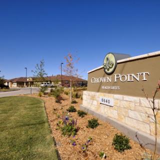 Entrance to Dawn Point, featuring well-maintained landscaping and clear blue skies.