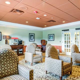 A cozy lounge area featuring patterned chairs and soft lighting.