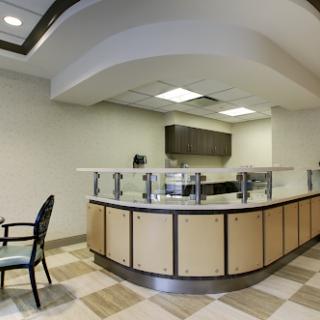 A modern reception area featuring a sleek counter and minimalistic design.