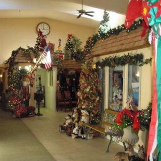 A festive indoor scene filled with Christmas decorations, including garlands and wreaths.