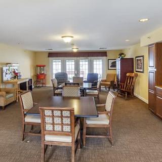 A cozy living room with arranged seating and tables.