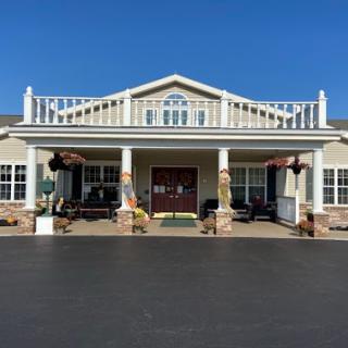 A beautiful residential home featuring a spacious front porch and elegant architectural details.