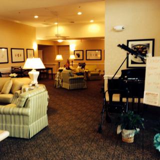 A cozy lounge area with comfortable seating and a piano.