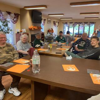 A group of people enjoying a social gathering in a cozy indoor setting.